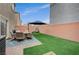 Private backyard with patio furniture and artificial turf at 5266 Sherwood Forest Ln, Las Vegas, NV 89122