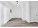 White hallway with wood-look floors and door at 5266 Sherwood Forest Ln, Las Vegas, NV 89122