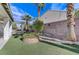 Landscaped backyard with artificial turf and pergola at 673 Kentons Run Ave, Henderson, NV 89052