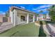 Backyard view with covered patio and grassy area at 673 Kentons Run Ave, Henderson, NV 89052