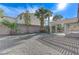 Gravel backyard with palm trees and covered patio at 673 Kentons Run Ave, Henderson, NV 89052