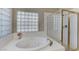 Bathroom with soaking tub, shower, and glass enclosure at 673 Kentons Run Ave, Henderson, NV 89052