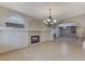 Spacious dining room with a fireplace and decorative chandelier at 673 Kentons Run Ave, Henderson, NV 89052