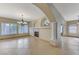 Elegant dining room with a chandelier, fireplace, and arched entryways at 673 Kentons Run Ave, Henderson, NV 89052