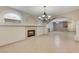 Open dining area featuring a fireplace and elegant chandelier at 673 Kentons Run Ave, Henderson, NV 89052