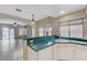 Kitchen features a corner sink, green laminate counters, and white cabinets at 673 Kentons Run Ave, Henderson, NV 89052