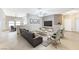 Spacious living room featuring a neutral color palette, tile floors, and a large flat-screen TV at 673 Kentons Run Ave, Henderson, NV 89052