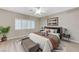 Main bedroom with wood-look floors, large window, and stylish decor at 673 Kentons Run Ave, Henderson, NV 89052