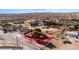 Panoramic aerial view of the cozy home nestled between barren landscape and mountains, and mature trees at 2925 Rice St, Logandale, NV 89021