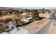 Birds eye view of brick home, mature trees and desert community backdrop at 2925 Rice St, Logandale, NV 89021