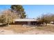 Spacious backyard featuring a patio, lawn, and brick exterior with double doors at 2925 Rice St, Logandale, NV 89021