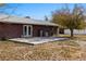 The backyard has a simple concrete patio and mature trees at 2925 Rice St, Logandale, NV 89021