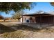 Exterior shot of the home showcasing the brick facade, concrete pad, and covered parking area at 2925 Rice St, Logandale, NV 89021