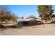 View of the home with covered parking and a spacious side yard at 2925 Rice St, Logandale, NV 89021