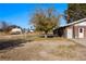 View of the home's exterior and yard showing the detached garage and brick facade at 2925 Rice St, Logandale, NV 89021