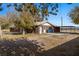 Exterior view of a brick home featuring a covered patio and side yard, combining comfort and convenience at 2925 Rice St, Logandale, NV 89021