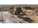 Quaint single-story home and well established trees with a view of a rural desert community at 2925 Rice St, Logandale, NV 89021