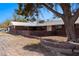 Charming brick home with a metal roof, landscaped yard, and mature trees at 2925 Rice St, Logandale, NV 89021