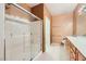 Bright bathroom featuring a glass-enclosed shower and a long wooden vanity with plenty of storage space at 7804 Island Rail Dr, North Las Vegas, NV 89084