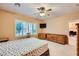 This bedroom has a ceiling fan, window shutters, and natural light at 7804 Island Rail Dr, North Las Vegas, NV 89084