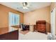 Cozy bedroom featuring neutral walls, bright window and a ceiling fan at 7804 Island Rail Dr, North Las Vegas, NV 89084