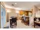 A sunlit breakfast nook features a dining table set and breakfast bar with seating at 7804 Island Rail Dr, North Las Vegas, NV 89084
