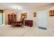 Traditional dining room featuring wooden table, china cabinet, chandelier, and neutral color scheme at 7804 Island Rail Dr, North Las Vegas, NV 89084
