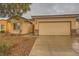 Street view of a one-story home with desert landscaping and a two-car garage, set on a quiet residential street at 7804 Island Rail Dr, North Las Vegas, NV 89084
