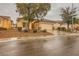 Charming single-story home featuring a well-manicured front yard with mature trees and a two-car garage at 7804 Island Rail Dr, North Las Vegas, NV 89084