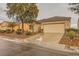 Attractive one-story home featuring a two-car garage and low-maintenance desert landscaping in the front yard at 7804 Island Rail Dr, North Las Vegas, NV 89084