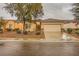 Inviting single-story home with desert landscaping and a spacious driveway leading to an attached two-car garage at 7804 Island Rail Dr, North Las Vegas, NV 89084
