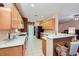 Well-lit kitchen featuring bright countertops, wooden cabinets, and modern appliances at 7804 Island Rail Dr, North Las Vegas, NV 89084