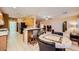 This open-concept kitchen has stainless appliances, a breakfast bar, and a dining nook at 7804 Island Rail Dr, North Las Vegas, NV 89084