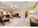 Spacious living room with plush carpeting, neutral walls, and ample natural light, ideal for relaxation and entertainment at 7804 Island Rail Dr, North Las Vegas, NV 89084