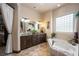Elegant bathroom with double vanity, soaking tub, and large window at 1004 Crest View Dr, Mesquite, NV 89027