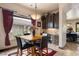 Breakfast nook features a wood table, four chairs, and a view from a large window at 1004 Crest View Dr, Mesquite, NV 89027