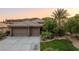 Single story home with two-car garage and manicured lawn at 1004 Crest View Dr, Mesquite, NV 89027
