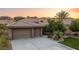 Single story home with two-car garage and manicured lawn at 1004 Crest View Dr, Mesquite, NV 89027