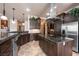 Modern kitchen with stainless steel appliances, granite counters, and dark wood cabinets at 1004 Crest View Dr, Mesquite, NV 89027