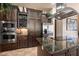 Well-equipped kitchen with double ovens, granite counters, and rich wood cabinets at 1004 Crest View Dr, Mesquite, NV 89027