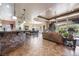 Open concept living room with stone accent wall and large windows at 1004 Crest View Dr, Mesquite, NV 89027