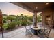 Covered patio with fire pit and seating area, overlooking the backyard at 1004 Crest View Dr, Mesquite, NV 89027