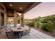 Relaxing patio with fire pit and seating area, overlooking a landscaped backyard at 1004 Crest View Dr, Mesquite, NV 89027