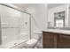 Bathroom featuring a glass-enclosed shower, toilet, and vanity with granite countertop at 4490 Rabnor Cir, Las Vegas, NV 89115