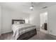 Bedroom with neutral carpet, ceiling fan, window, and wood-look bed frame with stylish bedding at 4490 Rabnor Cir, Las Vegas, NV 89115