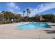 Community pool surrounded by mature trees and landscaping, offering a refreshing retreat at 4490 Rabnor Cir, Las Vegas, NV 89115