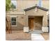 Exterior front view of a two-story house with a covered porch and desert landscaping at 4490 Rabnor Cir, Las Vegas, NV 89115