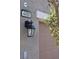 Close-up of a modern garage exterior with house number and lantern at 4490 Rabnor Cir, Las Vegas, NV 89115