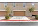 Attached garages with contemporary doors and well-kept landscaping at 4490 Rabnor Cir, Las Vegas, NV 89115