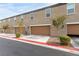 Row of garages on a modern townhome exterior, each with unique unit numbers at 4490 Rabnor Cir, Las Vegas, NV 89115